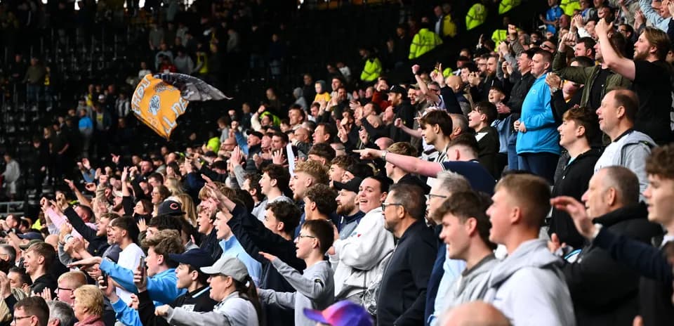 Supporters cheering and celebrating in the stands