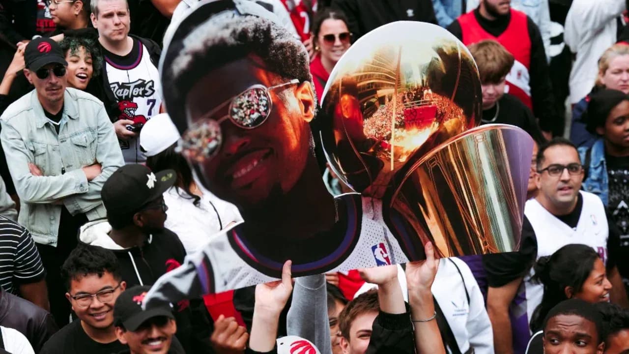 Supporters holding a sign and trophy at celebration