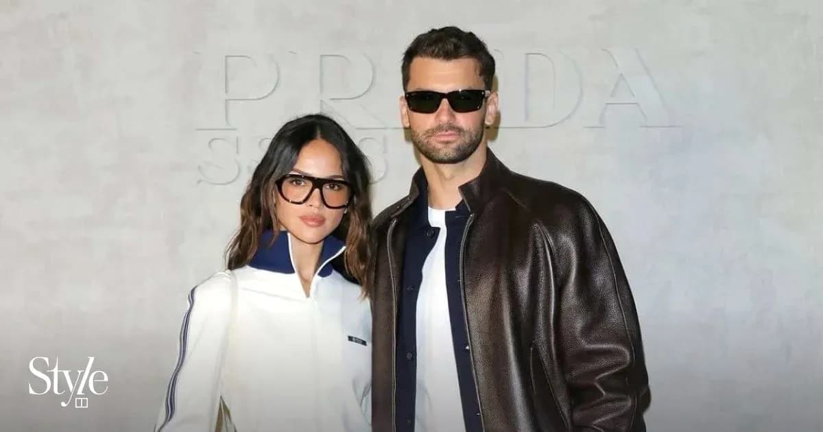 Couple posing in front of Prada backdrop