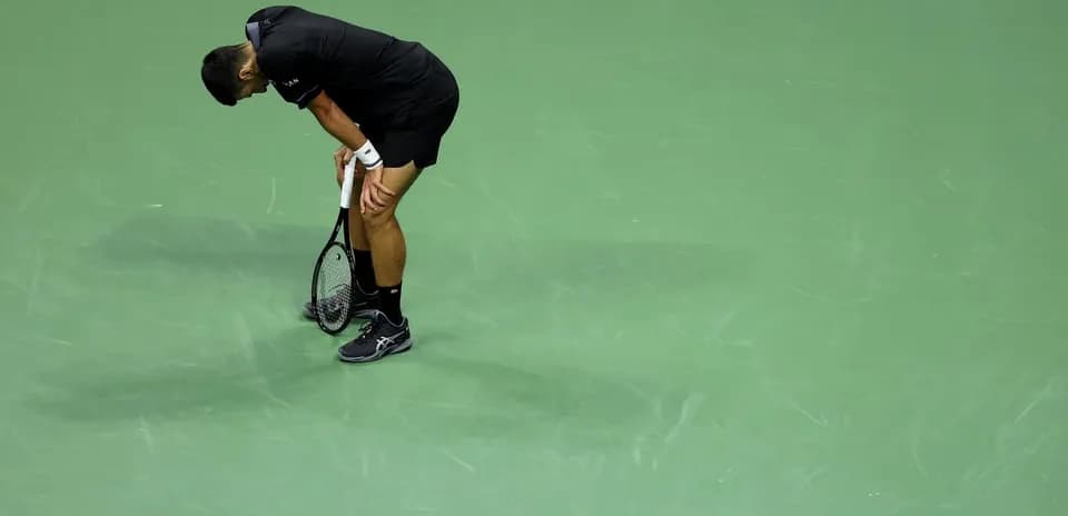 Joueur de tennis se penchant sur le court vert