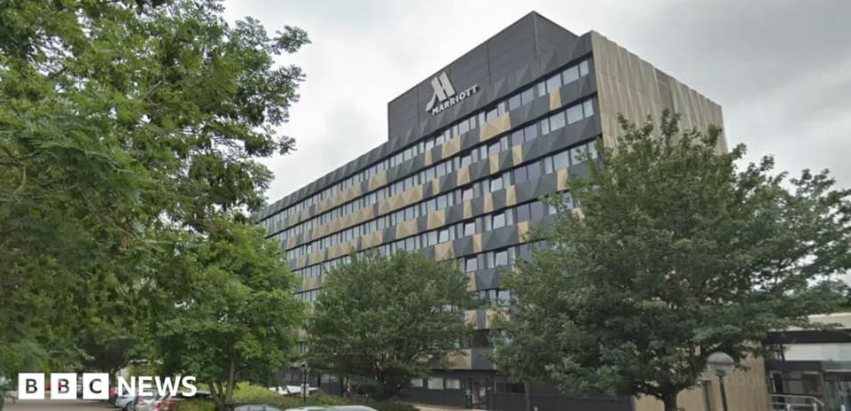 Hôtel Marriott avec arbres et voitures stationnées