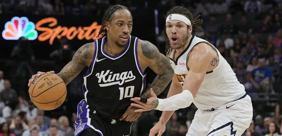 Joueur des Kings dribblant face à un défenseur des Nuggets