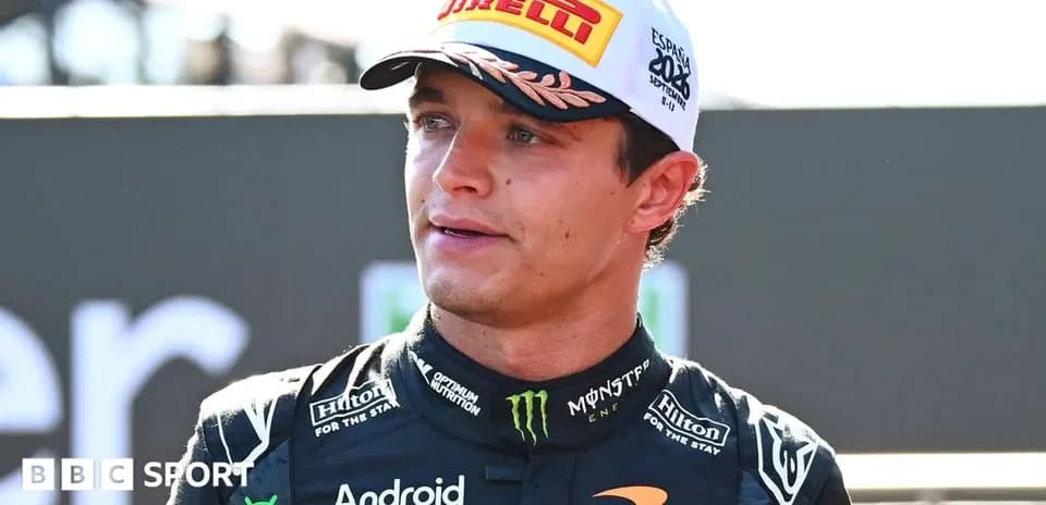 Pilote de Formule 1 en tenue McLaren sur podium