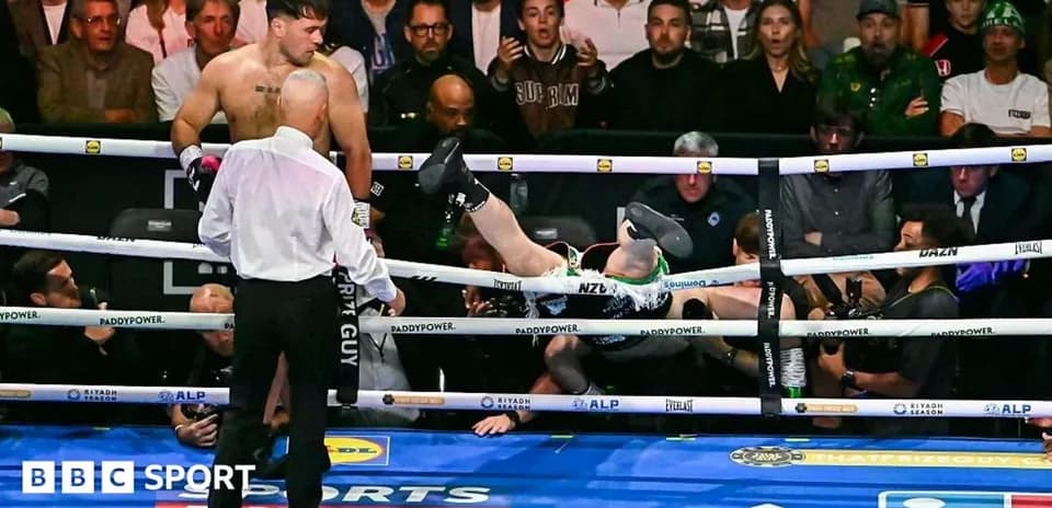 Boxer falling out of the ring during match
