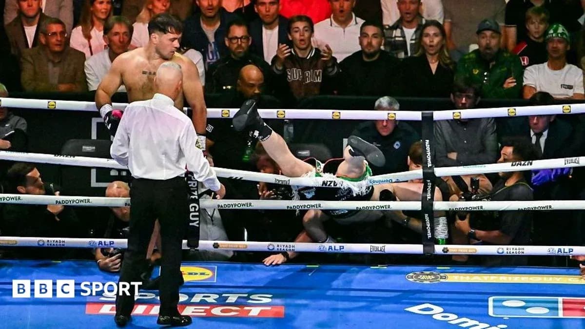 Boxer falling out of the ring during match