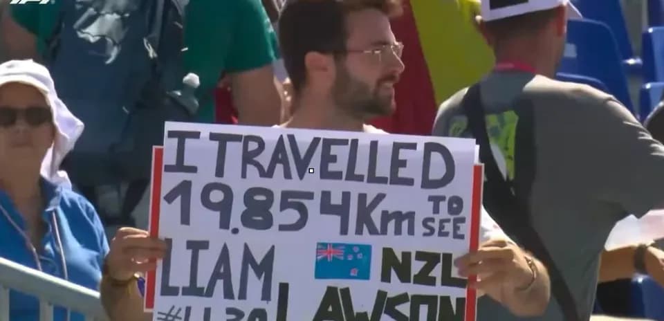 Spectator holding sign supporting Liam Lawson at event