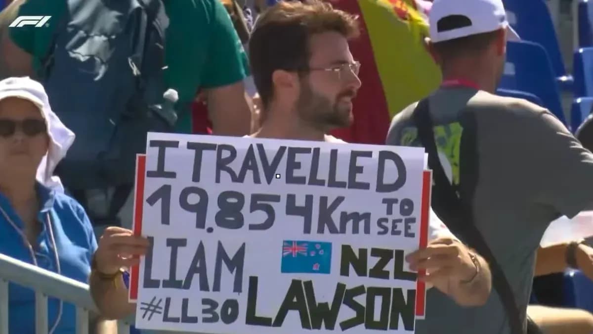 Spectator holding sign supporting Liam Lawson at event