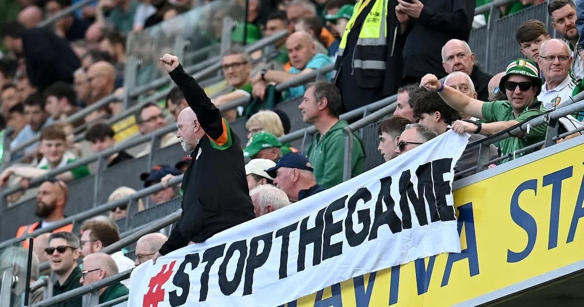 Supporters holding a banner at a stadium