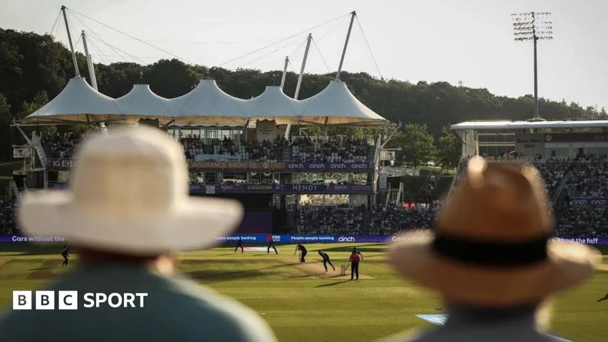 Spectators watching cricket match at stadium