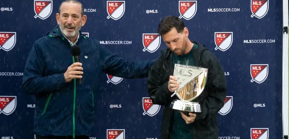 Messi holding MLS trophy during award presentation