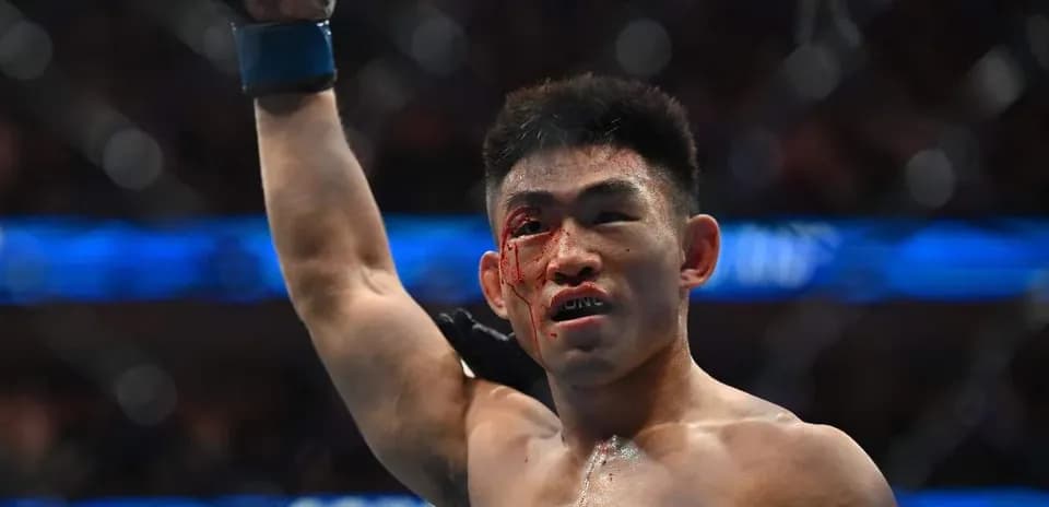 Fighter celebrating victory with bloodied face