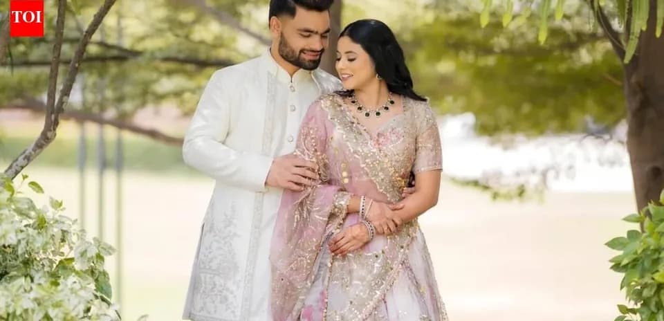 Couple in traditional attire posing outdoors