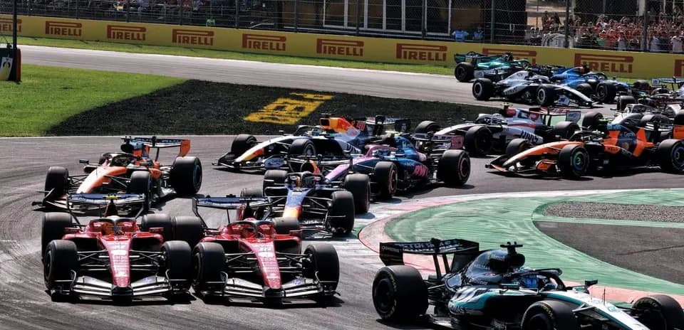 Multiple Formula 1 cars racing on track during event