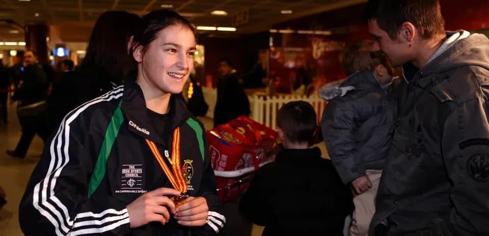 Athlete with medal chatting at airport