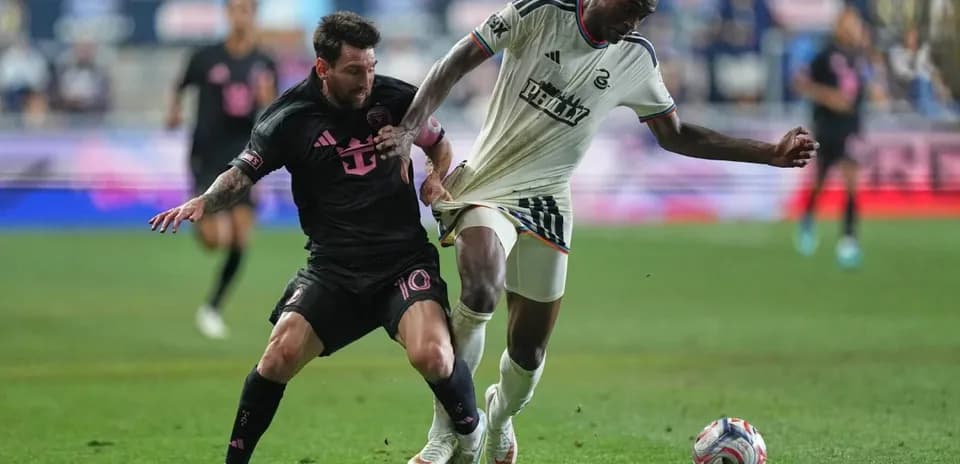 Messi challenging opponent for the ball during match
