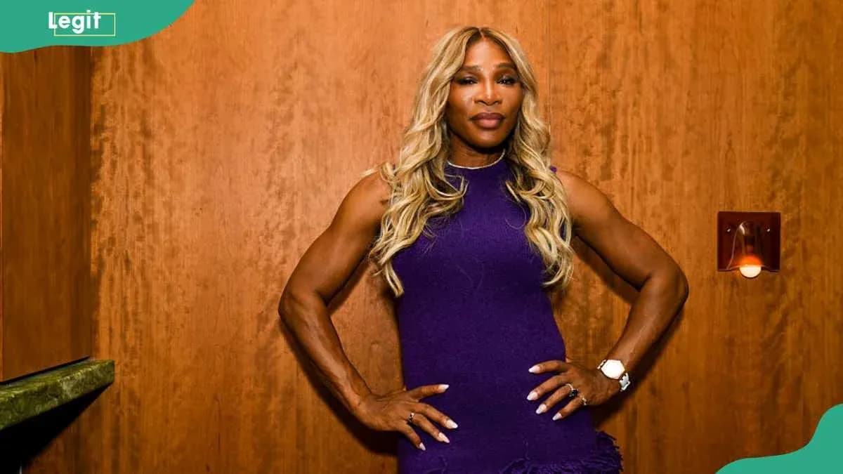 Athlete posing confidently against wooden backdrop