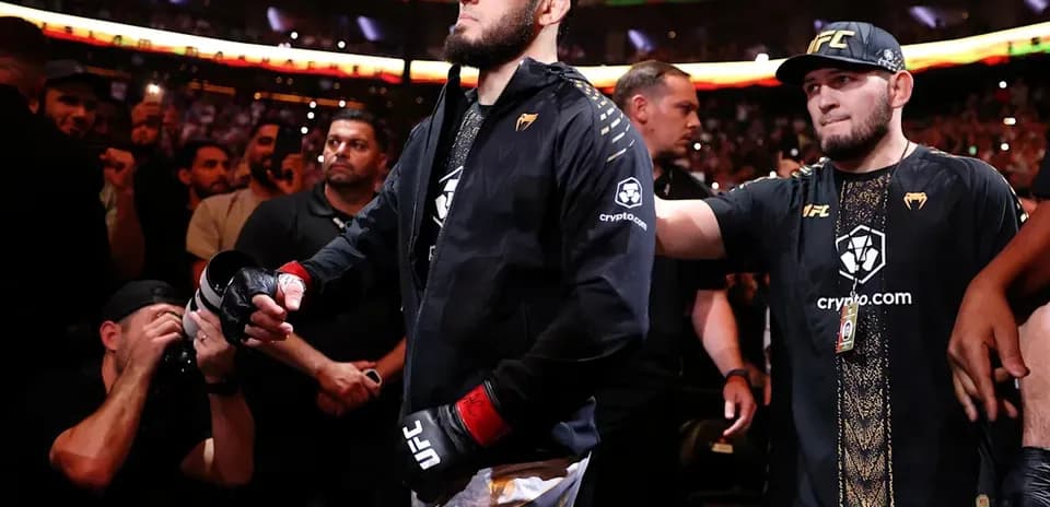Fighter entering the arena surrounded by supporters