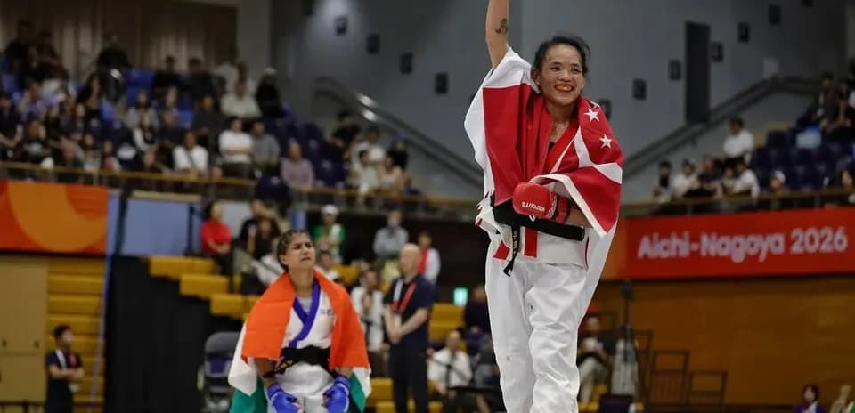 Athlete celebrating victory with raised arm in competition