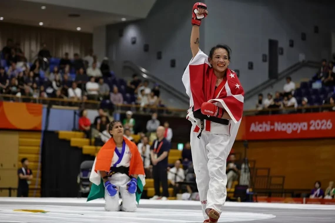 Athlete celebrating victory with raised arm in competition