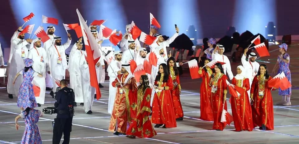 Participants from Bahrain celebrating with flags at event