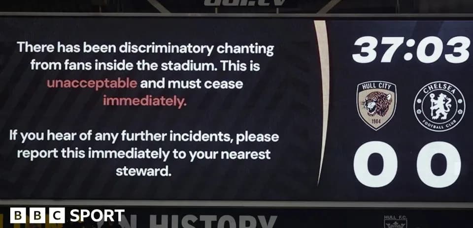 Stadium screen displaying warning about discriminatory chanting