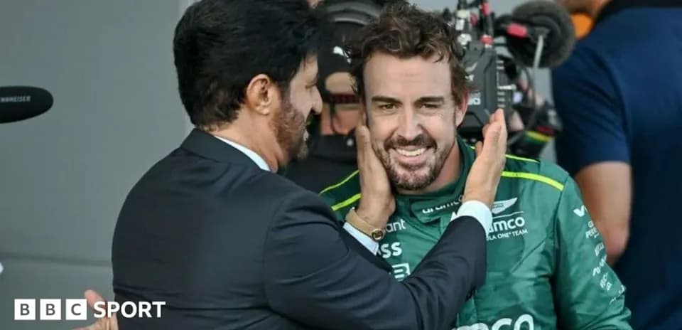 Fernando Alonso smiling with a team member after race