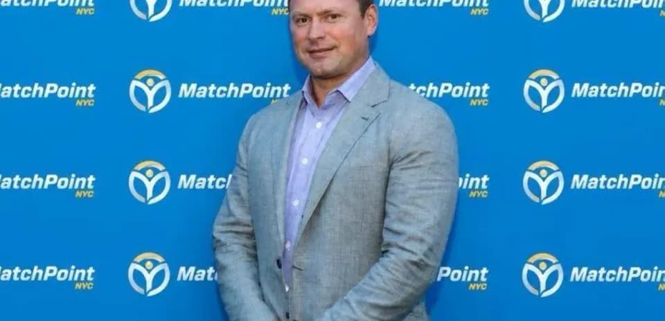 Homme posant devant un mur de MatchPoint NYC