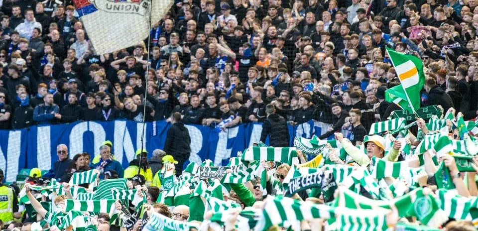 Supporters waving scarves during football match