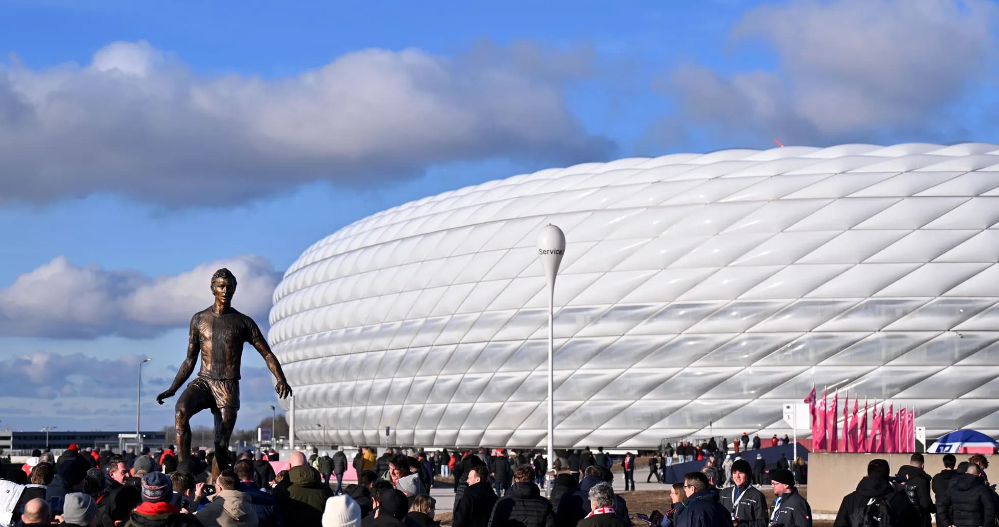 Statue of player in front of stadium with fans Statue of player in front of stadium with fans