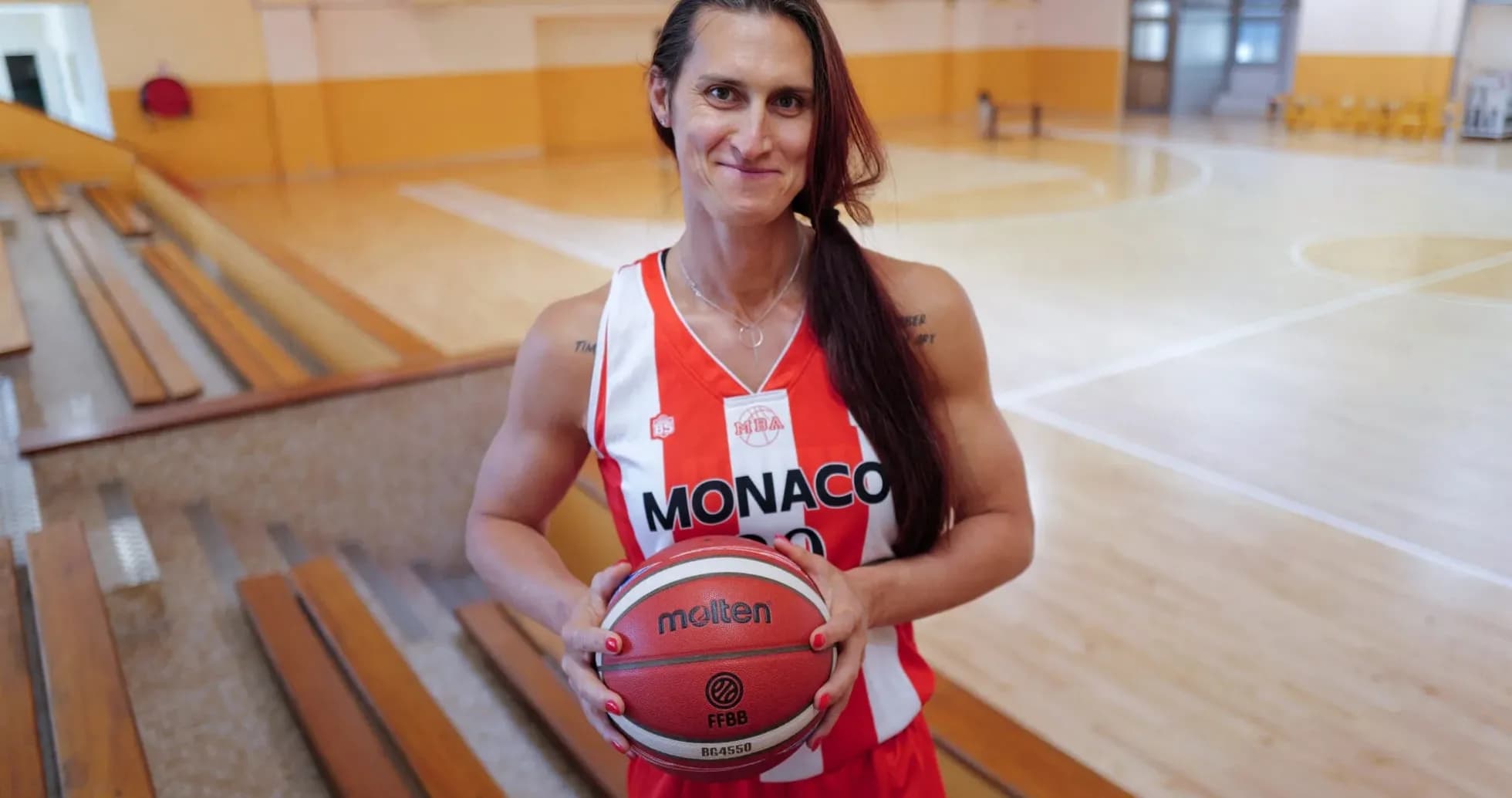 Joueuse de basket tenant un ballon sur le terrain Joueuse de basket tenant un ballon sur le terrain