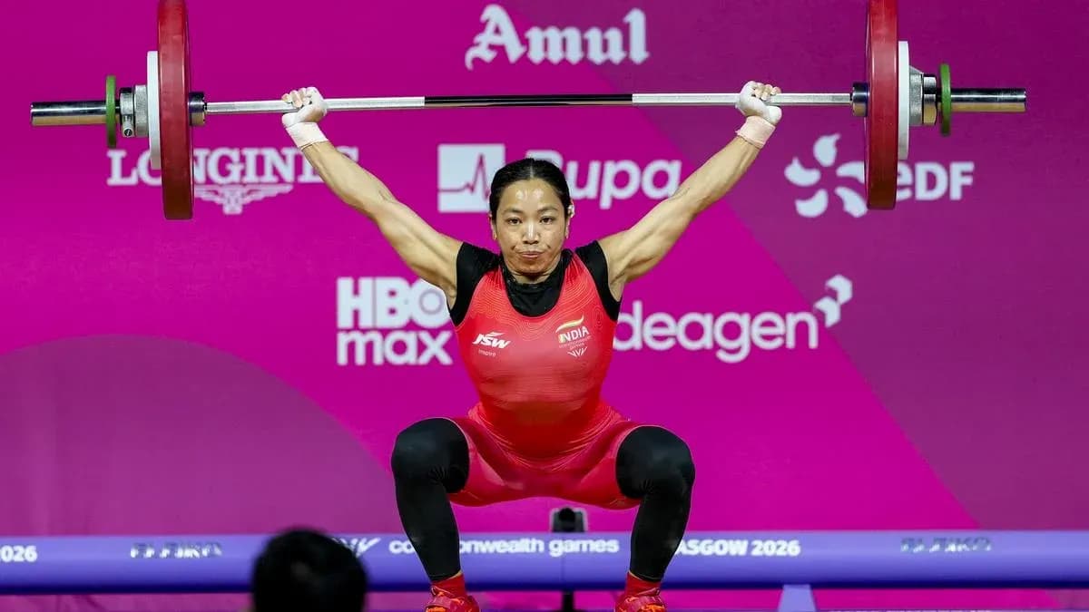 Athlete lifting barbell during weightlifting competition Athlete lifting barbell during weightlifting competition
