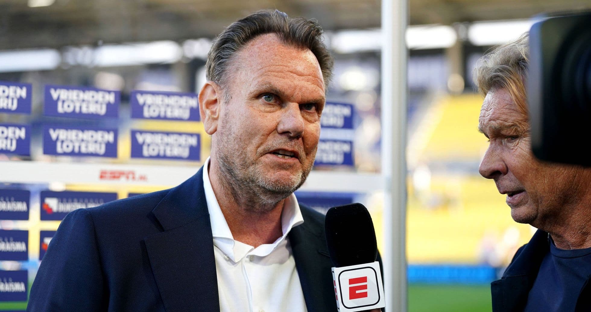 Interviewer speaking to a sports figure at event Interviewer speaking to a sports figure at event