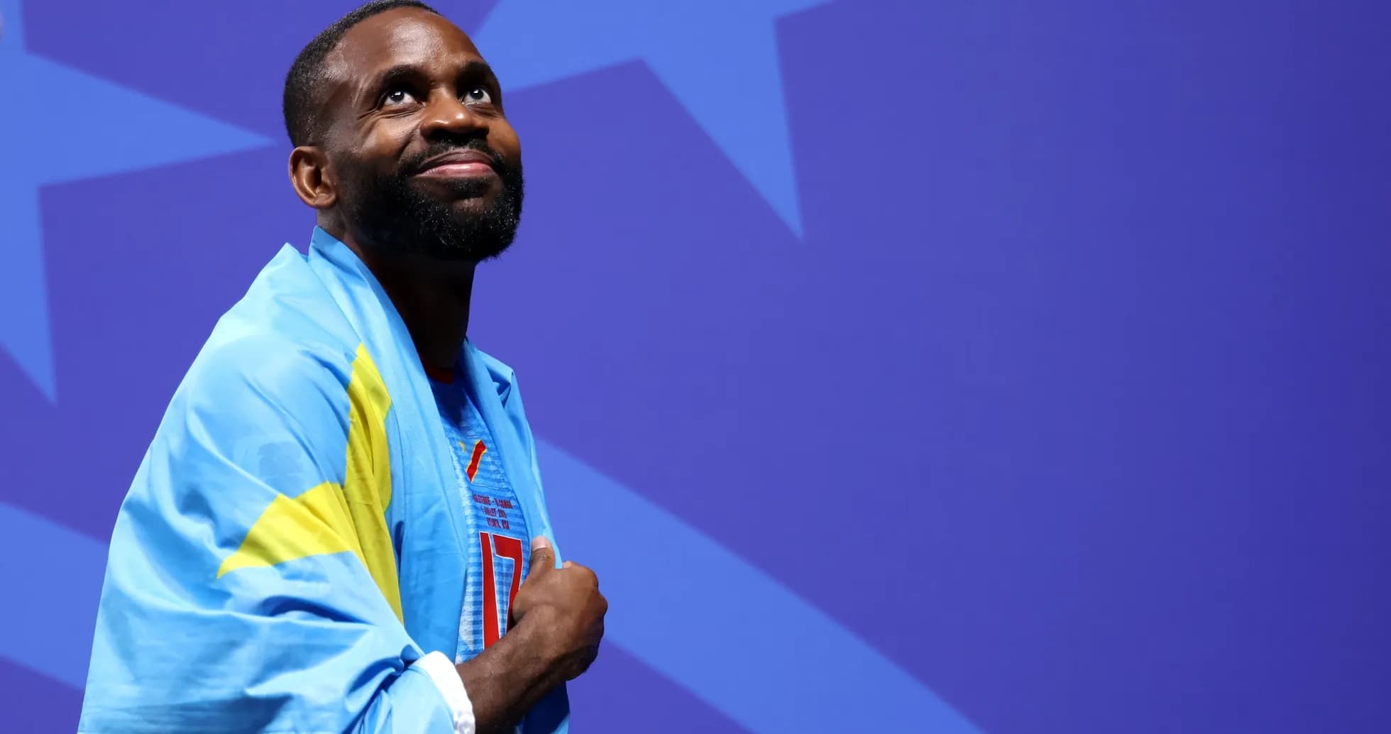 Athlete with flag smiling during event ceremony Athlete with flag smiling during event ceremony