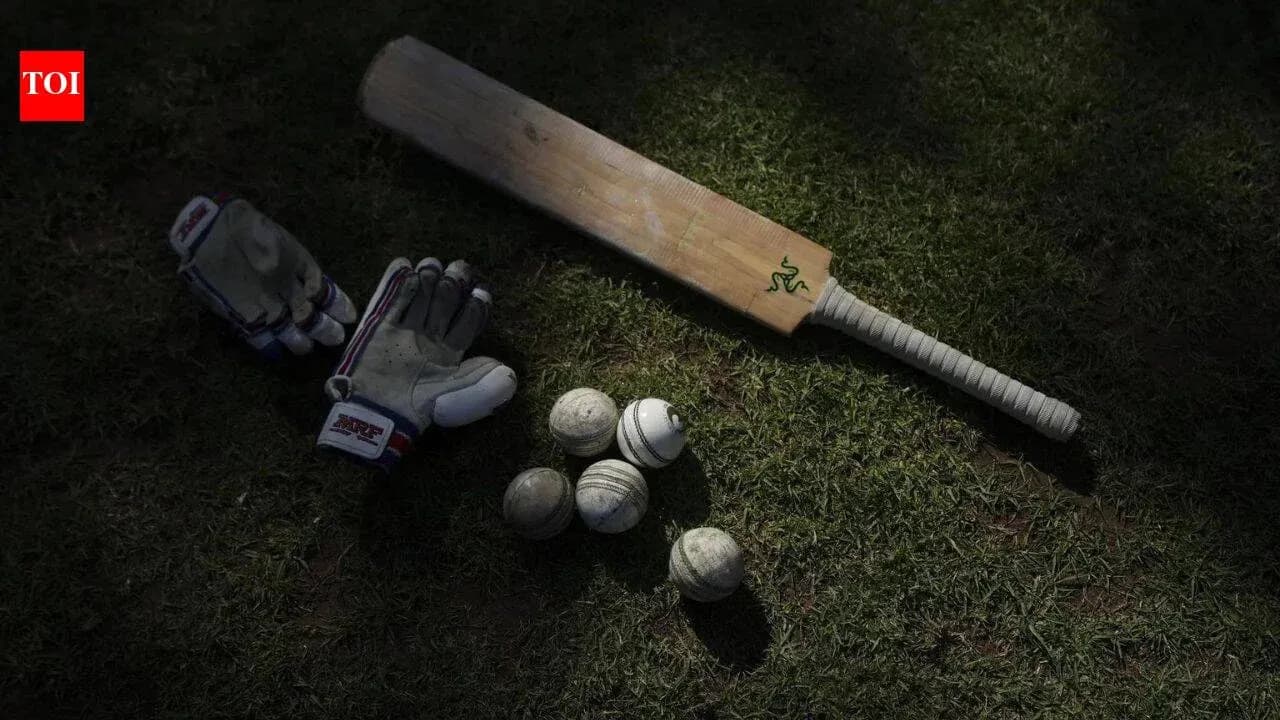 Bat, gloves, and balls on grassy field Bat, gloves, and balls on grassy field