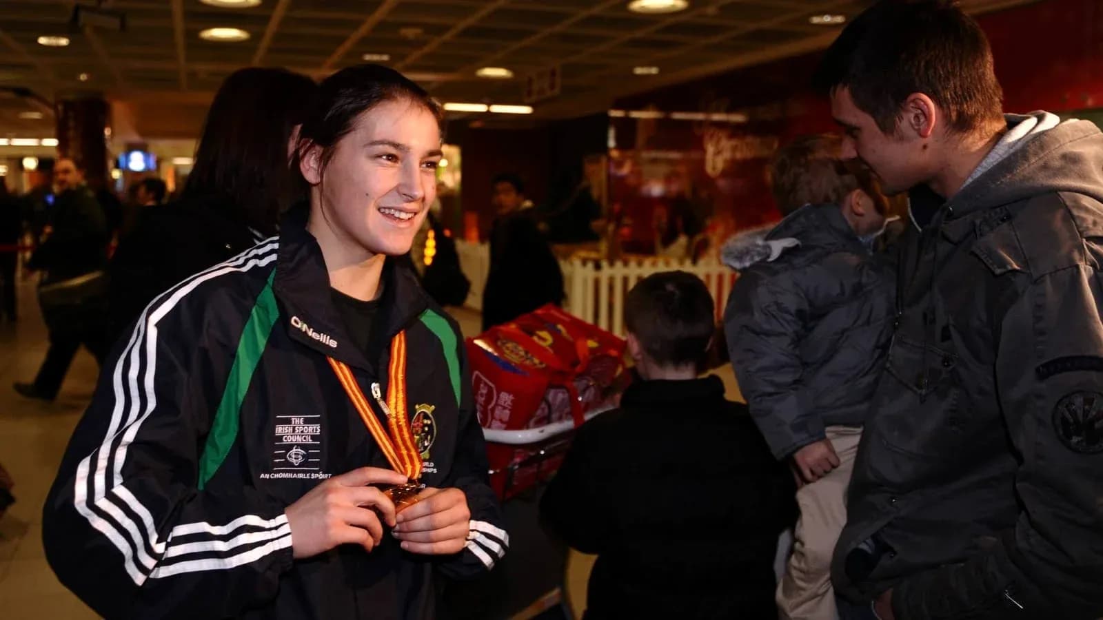 Athlete with medal chatting at airport Athlete with medal chatting at airport