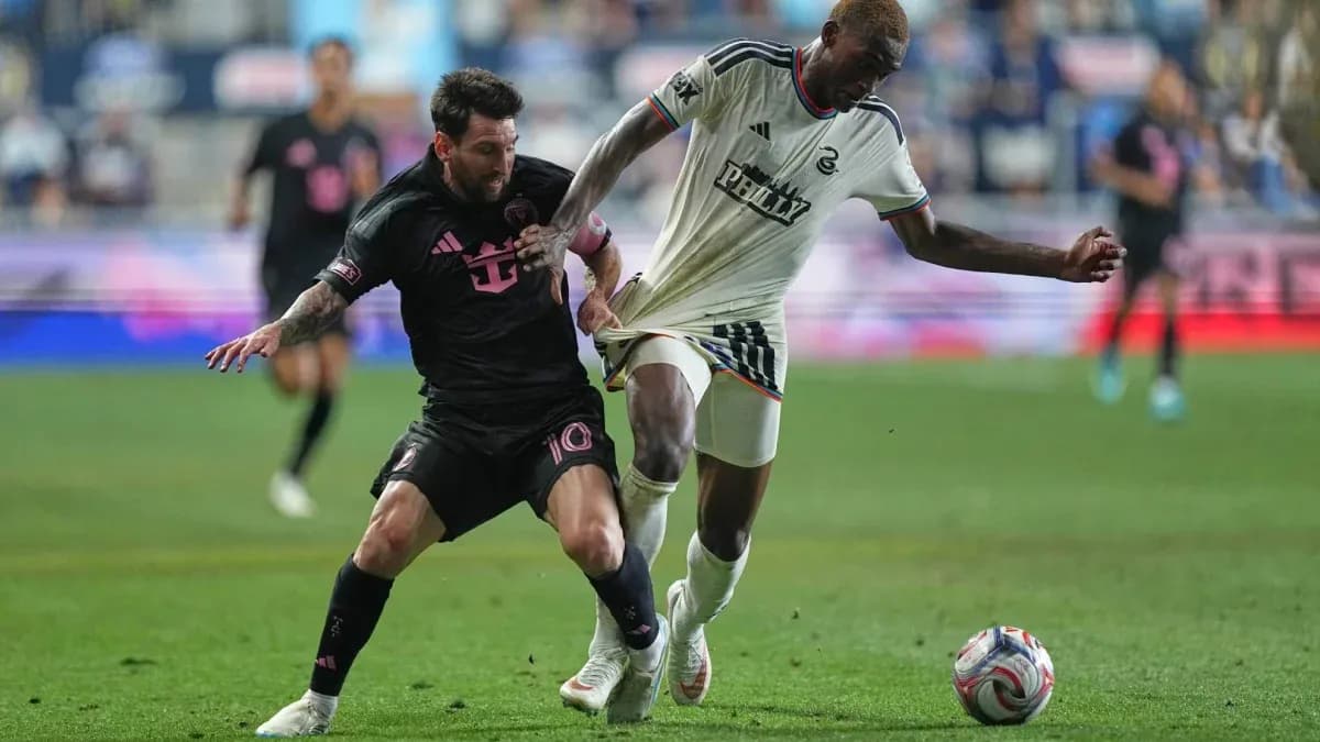 Messi challenging opponent for the ball during match Messi challenging opponent for the ball during match