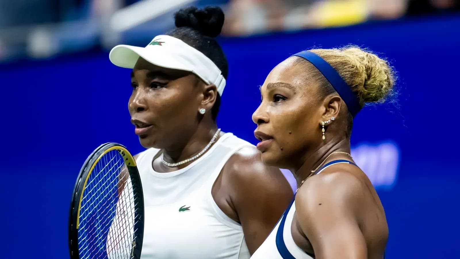 Venus et Serena Williams discutant sur le court Venus et Serena Williams discutant sur le court