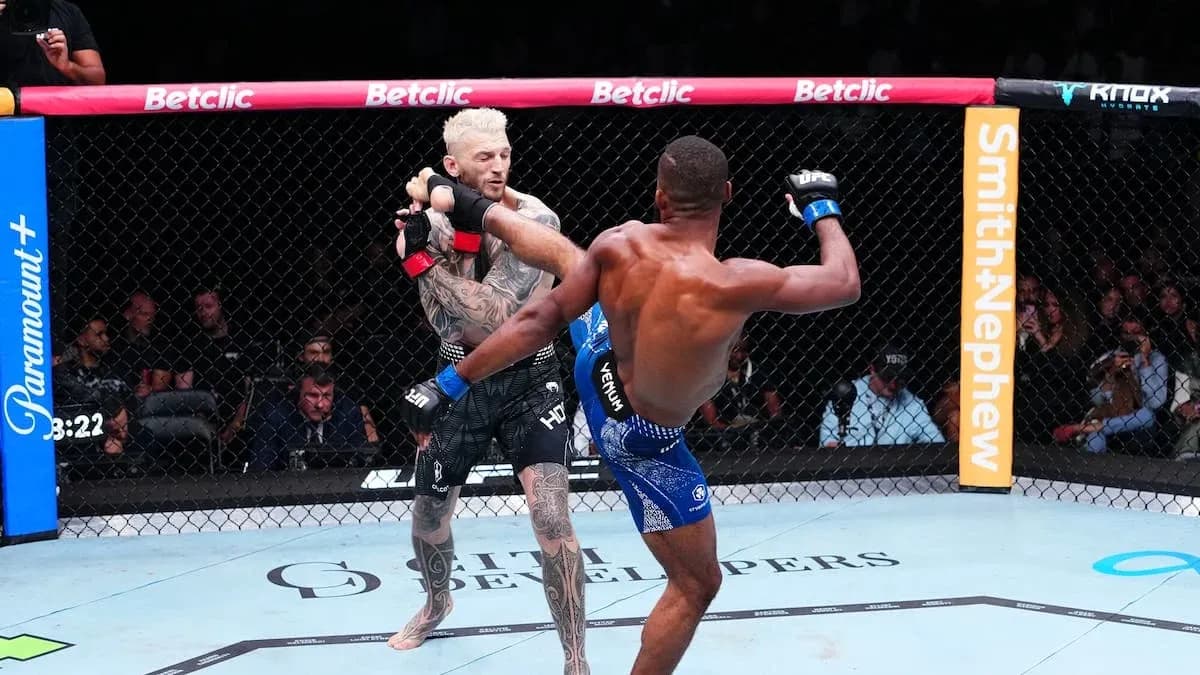 Combatants exchanging strikes in the octagon Combatants exchanging strikes in the octagon