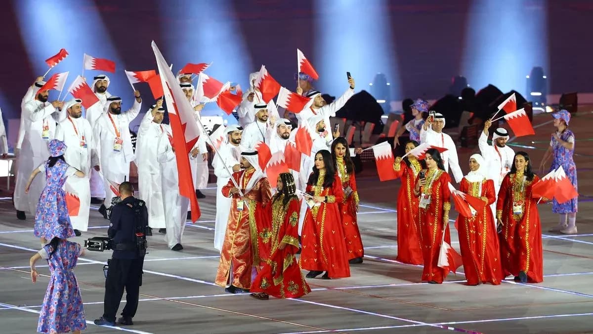 Participants from Bahrain celebrating with flags at event Participants from Bahrain celebrating with flags at event