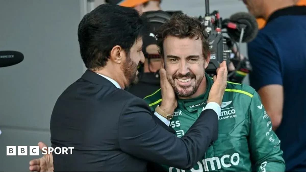 Fernando Alonso smiling with a team member after race Fernando Alonso smiling with a team member after race