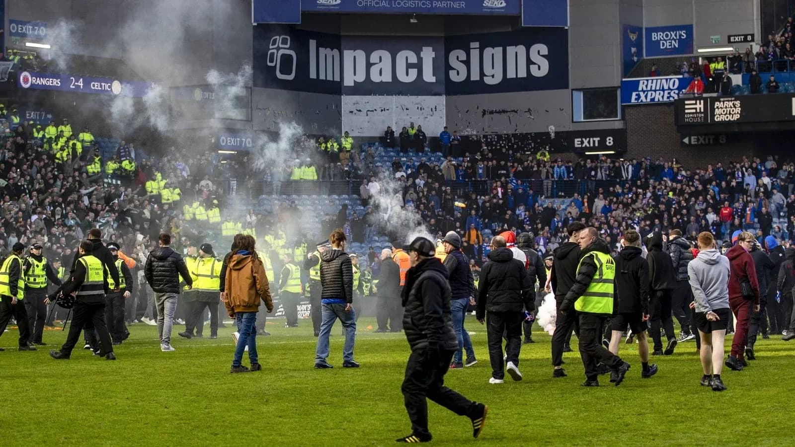 Supporters on the pitch after match disturbance Supporters on the pitch after match disturbance